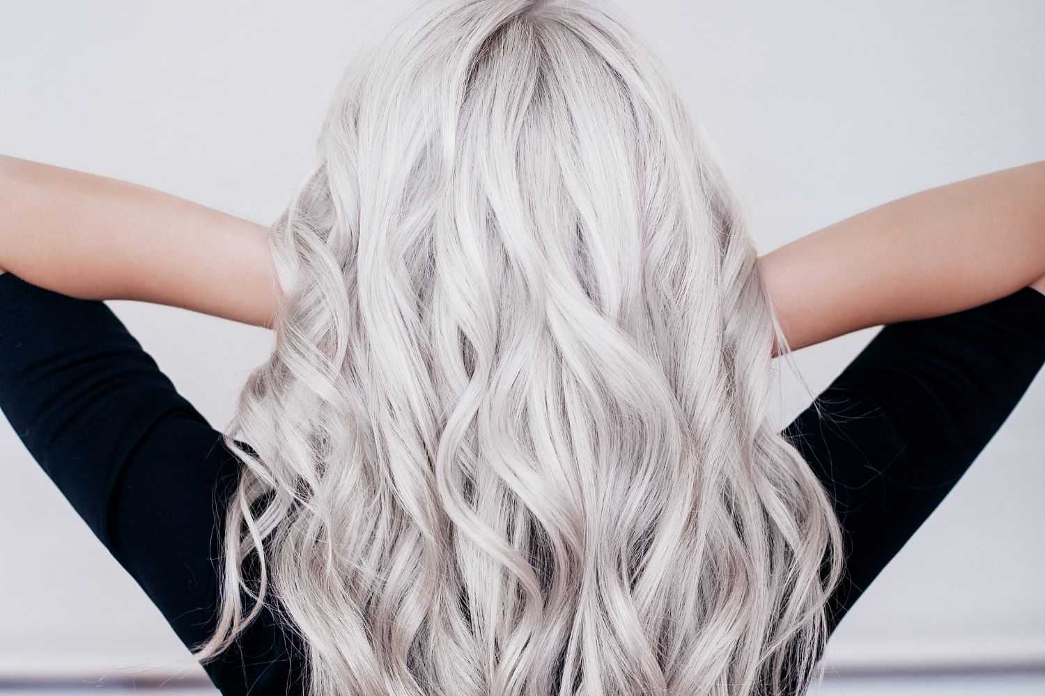 Person with long silver wavy hair from behind.